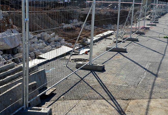 temporary fence panels surrounding a construction zone for safety measures